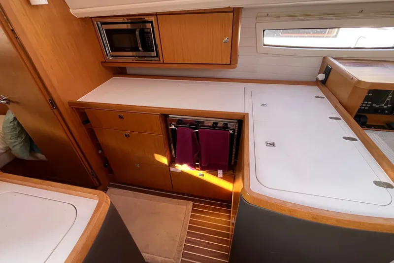 Slide: The Image of Interior of 2013 Bavaria Vision 46 yacht kitchen with wooden cabinetry and microwave. - 20