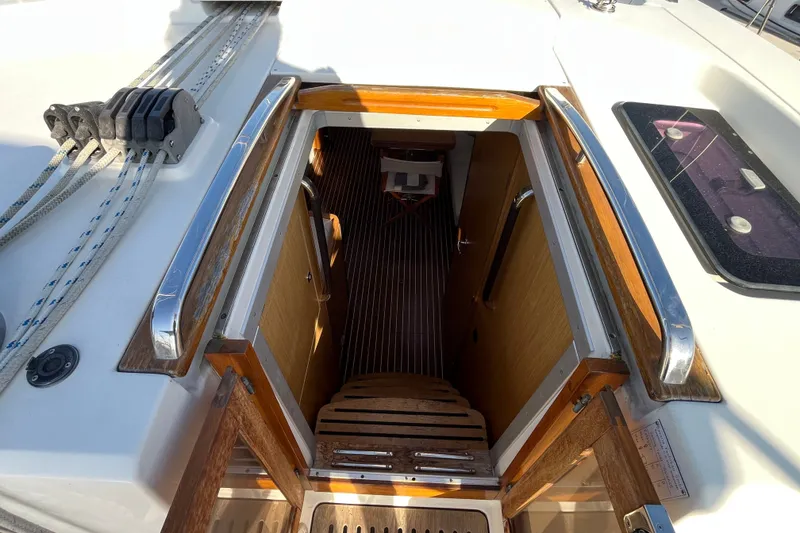 Slide: The Image of Entrance to cabin of 2013 Bavaria Vision 46 sailboat, featuring wooden steps and sleek design. - 15