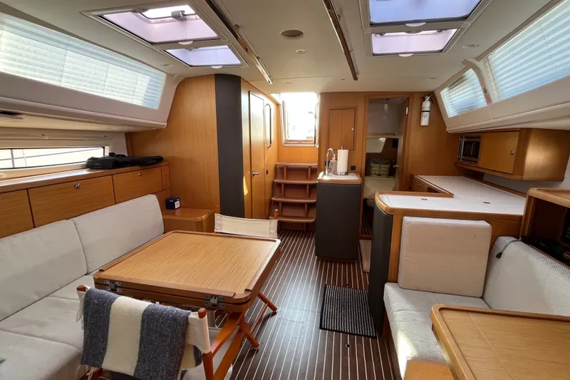 Slide: The Image of Interior of 2013 Bavaria Vision 46 yacht with modern wood finish and seating area. - 18