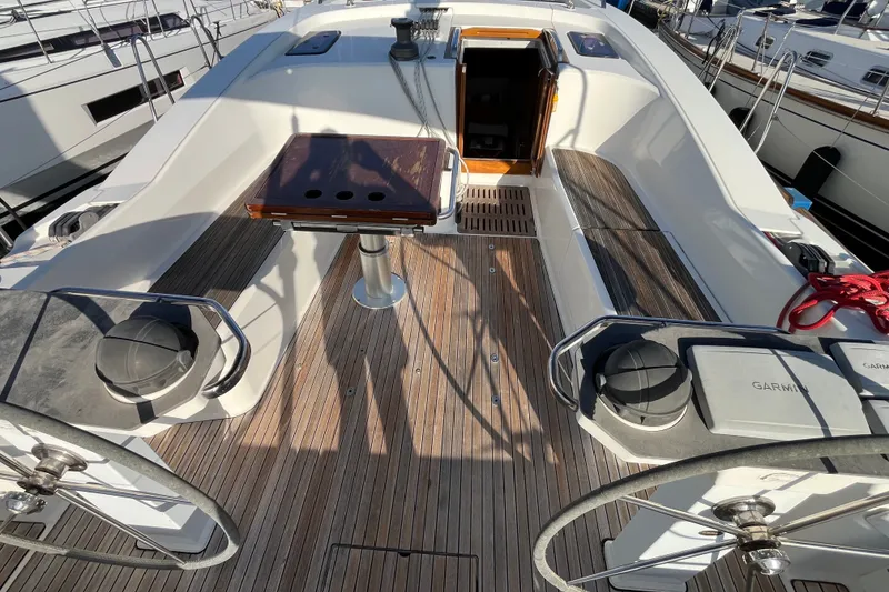 Slide: The Image of Cockpit of 2013 Bavaria Vision 46 sailboat with dual steering wheels and wooden deck. - 11