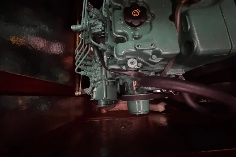 Slide: The Image of Engine compartment of a 2003 Bavaria Cruiser 44 sailboat, showcasing mechanical components. - 33