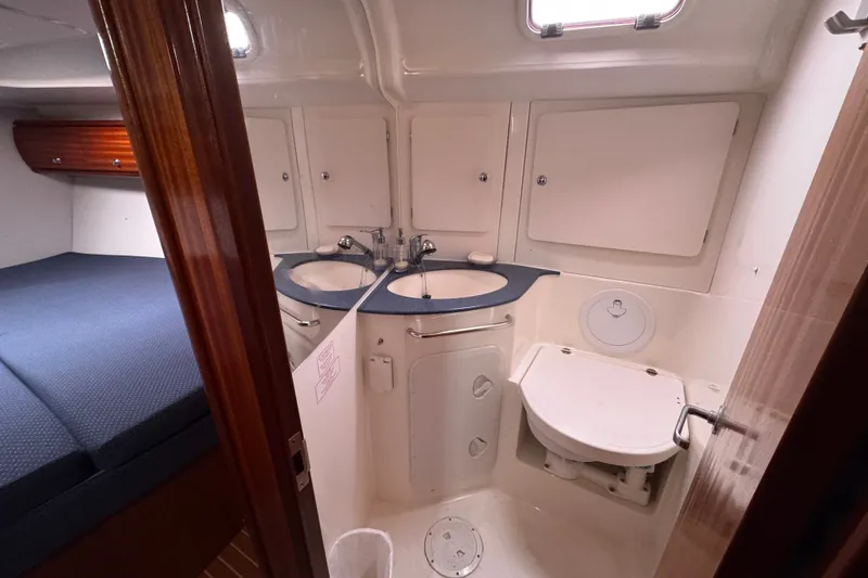Slide: The Image of Interior of 2003 Bavaria Cruiser 44 yacht showing bathroom and adjacent sleeping area. - 15