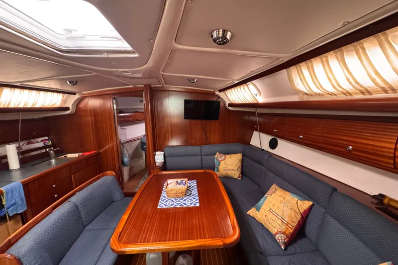 Slide: The Image of Interior of 2003 Bavaria Cruiser 44 yacht with cozy seating and wooden finishes. - 20