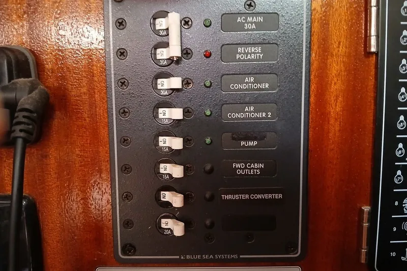 Slide: The Image of Electrical panel on a 2003 Bavaria Cruiser 44 yacht with labeled switches. - 21