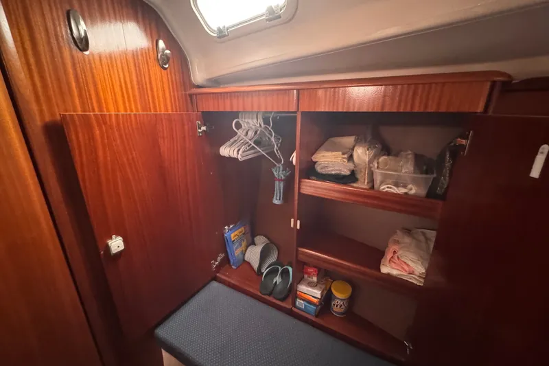 Slide: The Image of Wooden cabinet interior on a 2003 Bavaria Cruiser 44 yacht, with shelves and hangers. - 13