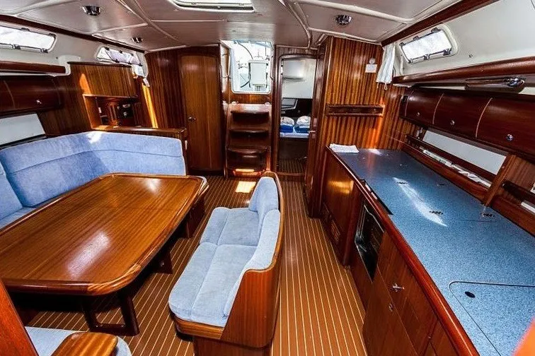 Slide: The Image of Interior of 2003 Bavaria Cruiser 44 yacht with wooden furnishings and blue upholstery. - 40
