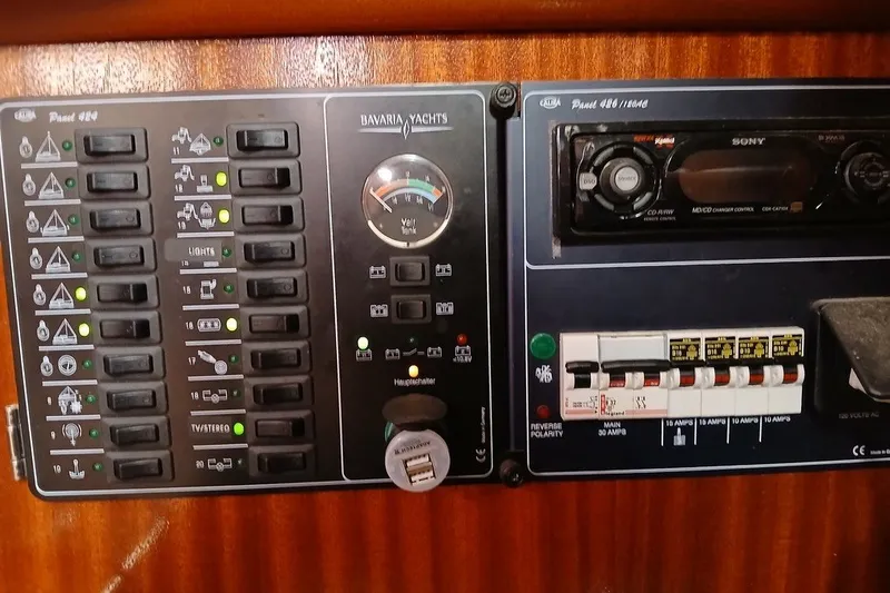 Slide: The Image of Control panel of a 2003 Bavaria Cruiser 44 yacht with switches and gauges. - 22