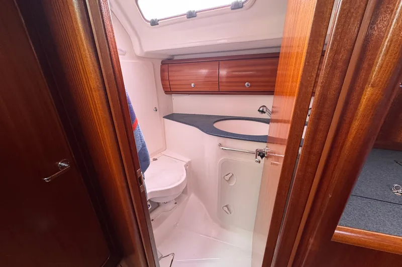 Slide: The Image of Interior of 2003 Bavaria Cruiser 44 yacht bathroom with wooden cabinetry and compact design. - 30
