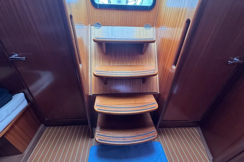 Slide: The Image of Interior wooden stairs of a 2003 Bavaria Cruiser 44 yacht cabin. - 25