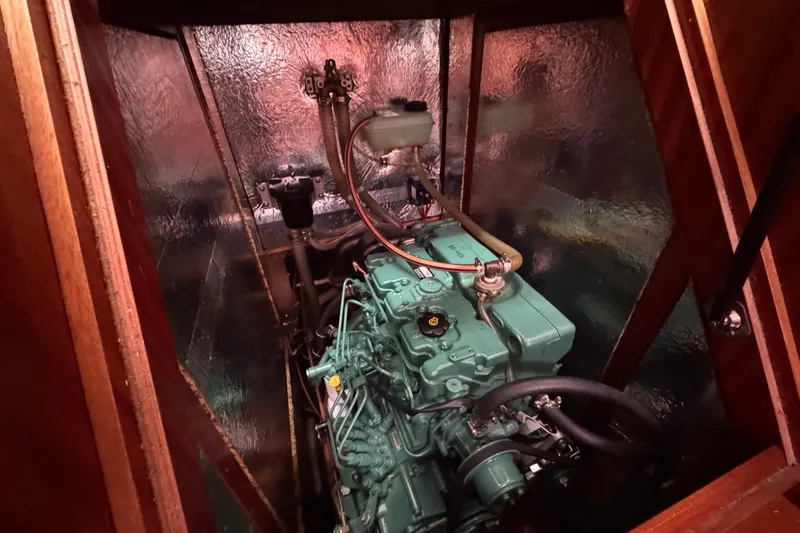 Slide: The Image of Engine compartment of a 2003 Bavaria Cruiser 44 sailboat, showcasing detailed mechanics. - 32