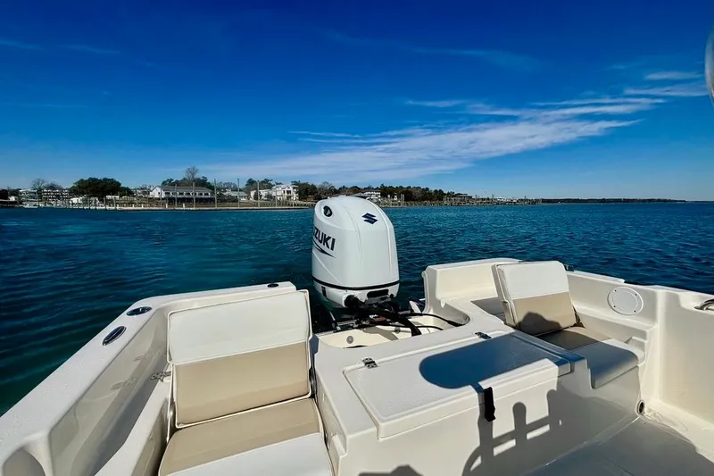 Slide: The Image of 2025 Bulls Bay 2200 XS boat with Suzuki engine on calm blue water. - 9