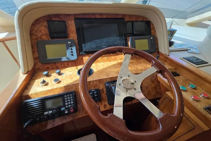 Slide: The Image of Helm of 2008 Neptunus Flybridge MY yacht with wooden steering wheel and navigation instruments. - 76