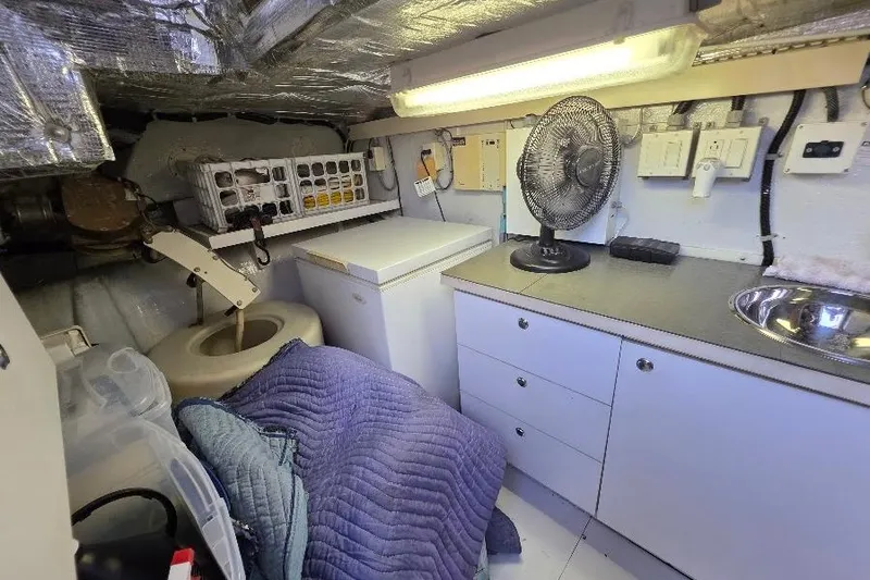 Slide: The Image of Utility room in 2008 Neptunus Flybridge MY yacht with fan, freezer, and storage. - 166