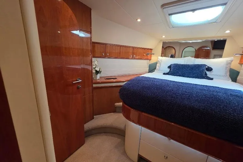 Slide: The Image of Luxurious 2008 Neptunus Flybridge MY yacht bedroom with elegant wood finishes and skylight. - 122
