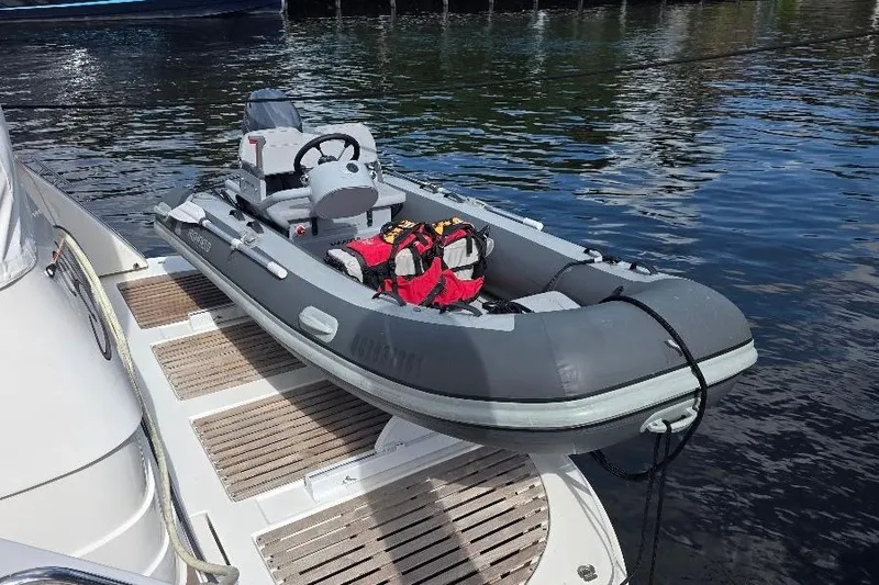 Slide: The Image of Inflatable dinghy on Neptunus Flybridge MY 2008 yacht platform, docked by the water. - 13