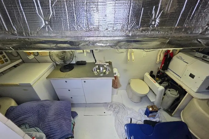 Slide: The Image of 2008 Neptunus Flybridge MY yacht interior with kitchenette, fan, and compact bathroom. - 168