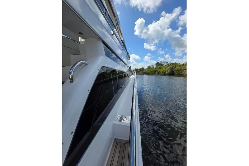 Slide: The Image of Side view of 2008 Neptunus Flybridge MY yacht on a calm river under blue sky. - 170
