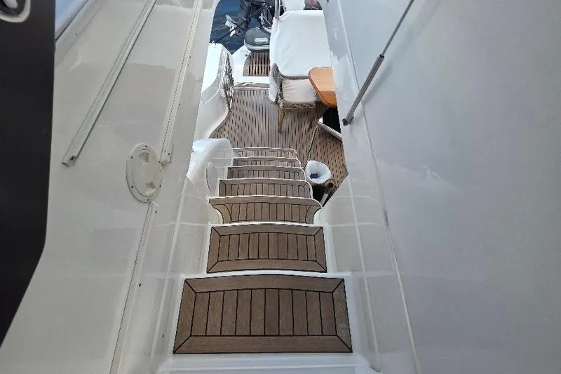Slide: The Image of Staircase on 2008 Neptunus Flybridge MY yacht with wooden steps and seating area. - 48