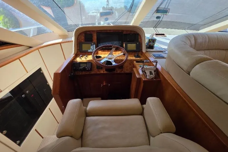 Slide: The Image of Helm of 2008 Neptunus Flybridge MY yacht with luxurious leather seating and navigation controls. - 75