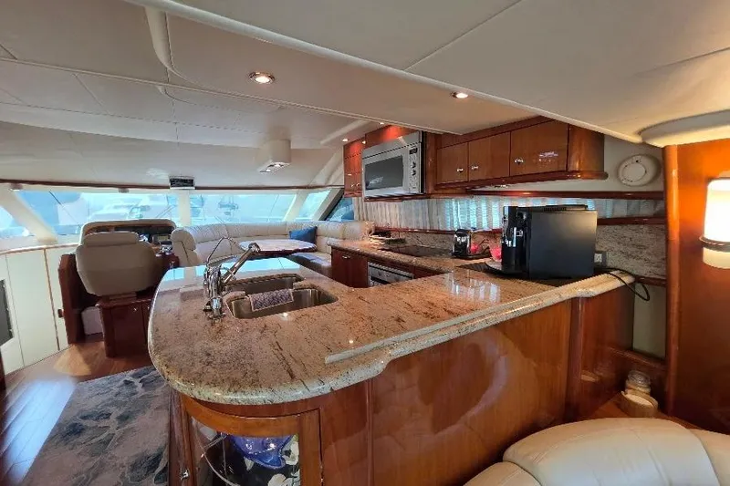 Slide: The Image of Luxurious 2008 Neptunus Flybridge MY yacht interior with modern kitchen and seating area. - 90