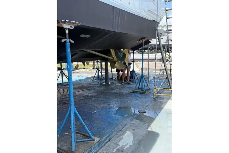 Slide: The Image of 2008 Neptunus Flybridge MY yacht under maintenance, supported by stands in a shipyard. - 176