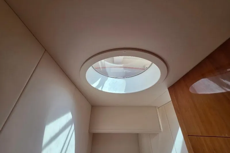 Slide: The Image of Circular skylight in 2008 Neptunus Flybridge MY yacht interior, illuminating wooden and white surfaces. - 109