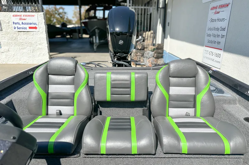Slide: The Image of 2019 Ranger RT178 boat interior with gray and green seats at a service center. - 10