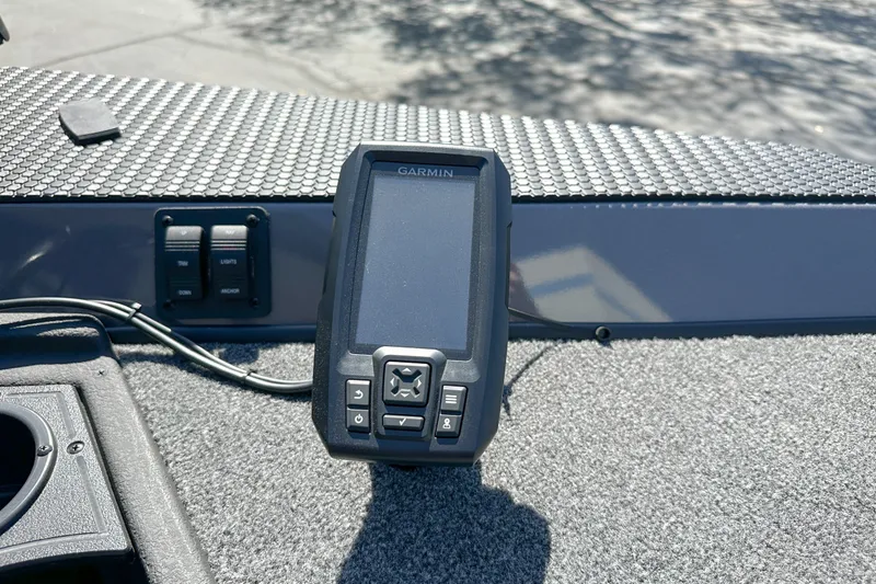 Slide: The Image of Garmin device on 2019 Ranger RT178 boat dashboard, featuring control buttons and textured surface. - 5