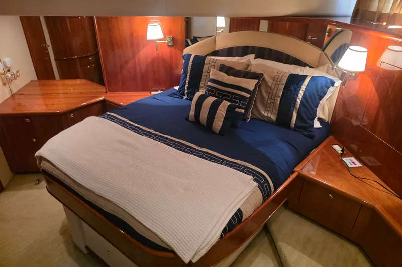 Slide: The Image of Luxurious bedroom interior of 2002 Neptunus 56 Flybridge yacht with elegant bedding and wood finishes. - 66