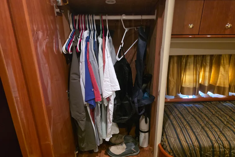 Slide: The Image of Closet in 2002 Neptunus 56 Flybridge yacht with hanging clothes and shoes. - 77