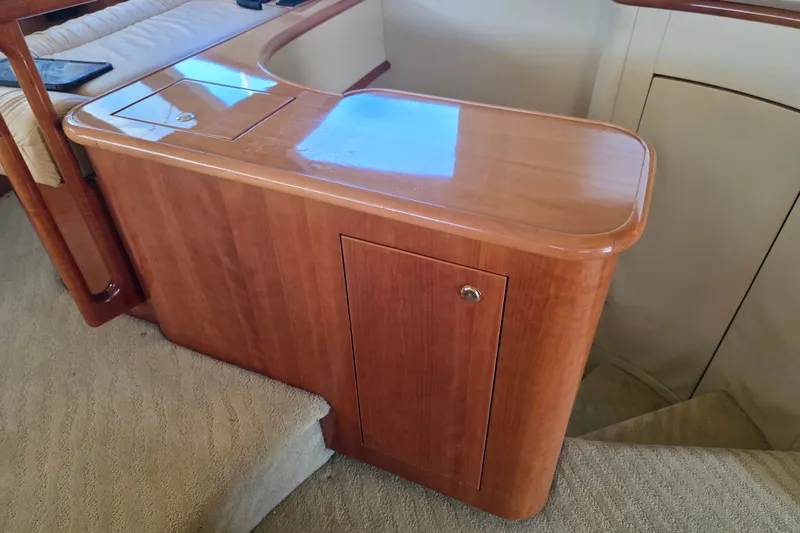 Slide: The Image of Luxurious wooden interior of 2002 Neptunus 56 Flybridge yacht, featuring elegant cabinetry and plush carpeting. - 54