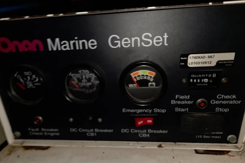 Slide: The Image of Onan Marine GenSet control panel with gauges and switches on a 2002 Neptunus 56 Flybridge. - 26