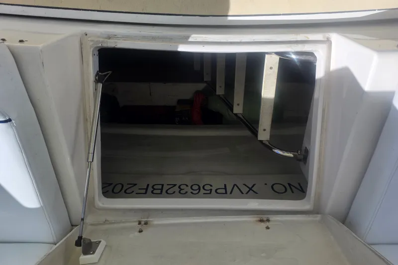 Slide: The Image of Open hatch on 2002 Neptunus 56 Flybridge yacht, revealing interior storage space. - 24