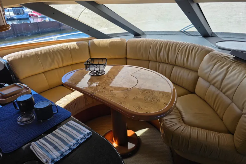 Slide: The Image of Luxurious Neptunus 56 Flybridge 2002 yacht interior with leather seating and elegant table. - 56