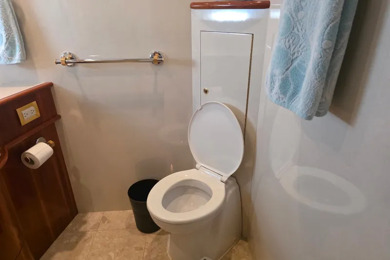 Slide: The Image of Bathroom interior of 2002 Neptunus 56 Flybridge yacht, featuring toilet and towel. - 71