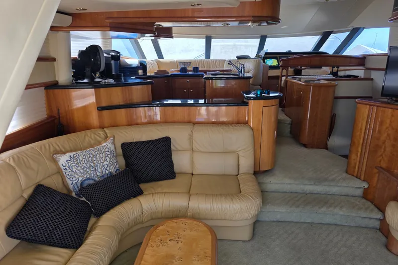 Slide: The Image of Luxurious interior of 2002 Neptunus 56 Flybridge yacht with elegant wood finishes and plush seating. - 49