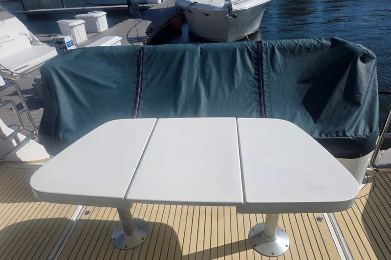 Slide: The Image of Flybridge seating area on 2002 Neptunus 56 yacht with covered bench and table. - 22