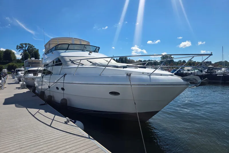 Slide: The Image of 2002 Neptunus 56 Flybridge yacht docked under a clear blue sky. - 1