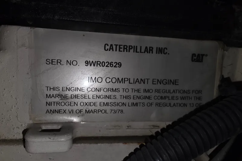 Slide: The Image of Caterpillar engine compliance label on 2002 Neptunus 56 Flybridge, showing IMO regulations adherence. - 36