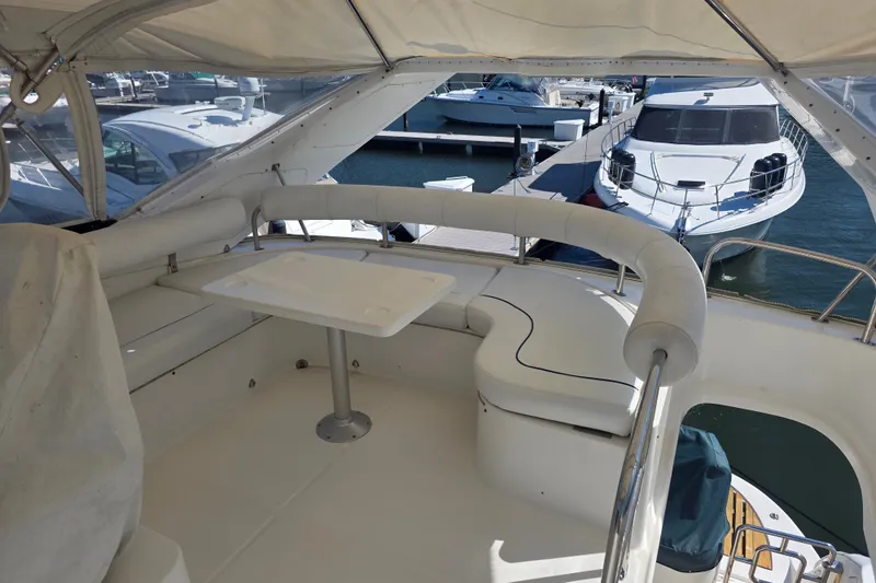 Slide: The Image of Flybridge seating area on 2002 Neptunus 56 yacht, docked at marina. - 12