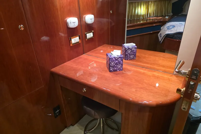 Slide: The Image of Luxurious wooden vanity area inside a 2002 Neptunus 56 Flybridge yacht cabin. - 86
