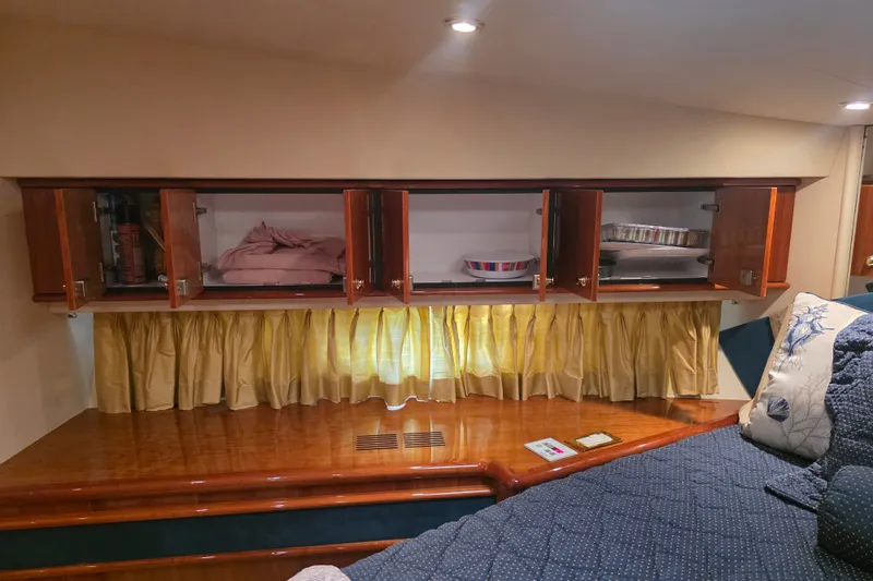 Slide: The Image of Luxurious 2002 Neptunus 56 Flybridge yacht interior with wooden cabinets and cozy bedding. - 84