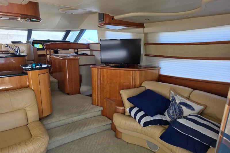 Slide: The Image of Luxurious interior of a 2002 Neptunus 56 Flybridge yacht with plush seating and modern amenities. - 51
