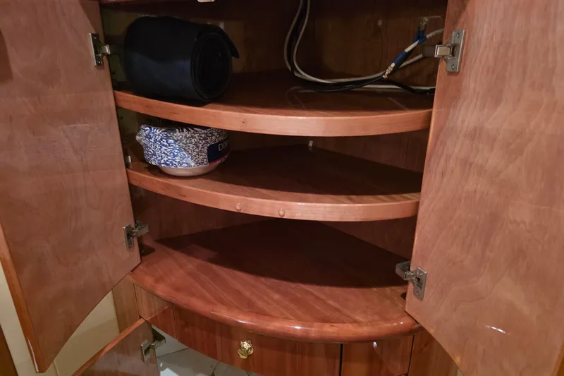 Slide: The Image of Open wooden cabinet with shelves on a 2002 Neptunus 56 Flybridge yacht. - 63