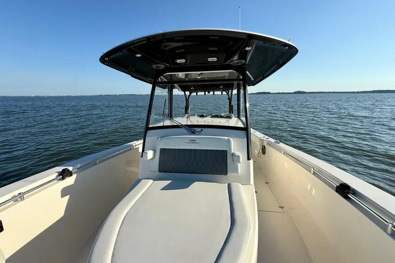 Slide: The Image of 2023 Cobia 350 Center Console boat on open water, showcasing spacious deck and seating. - 27