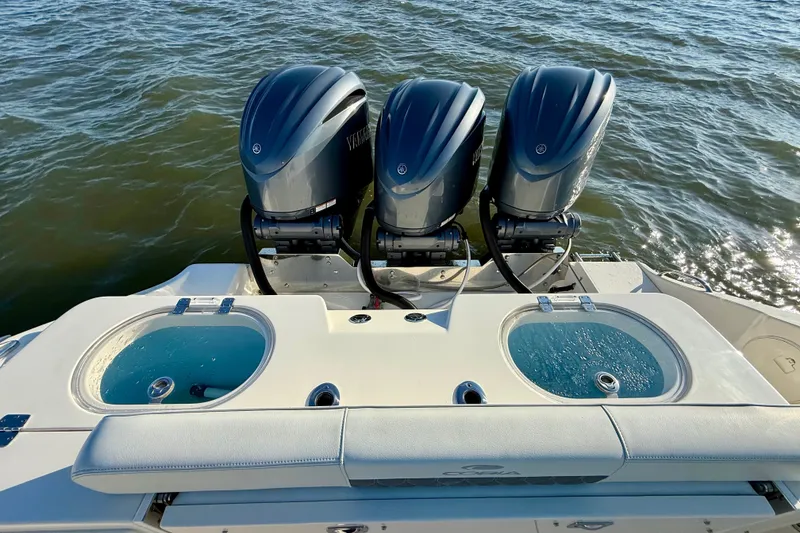 Slide: The Image of 2023 Cobia 350 Center Console with triple outboard engines on the water. - 17