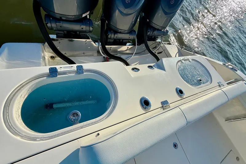 Slide: The Image of 2023 Cobia 350 Center Console boat with dual livewells and powerful outboard engines. - 15