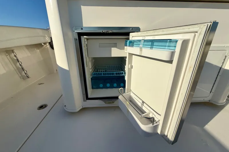 Slide: The Image of 2023 Cobia 350 Center Console boat with open onboard refrigerator. - 13