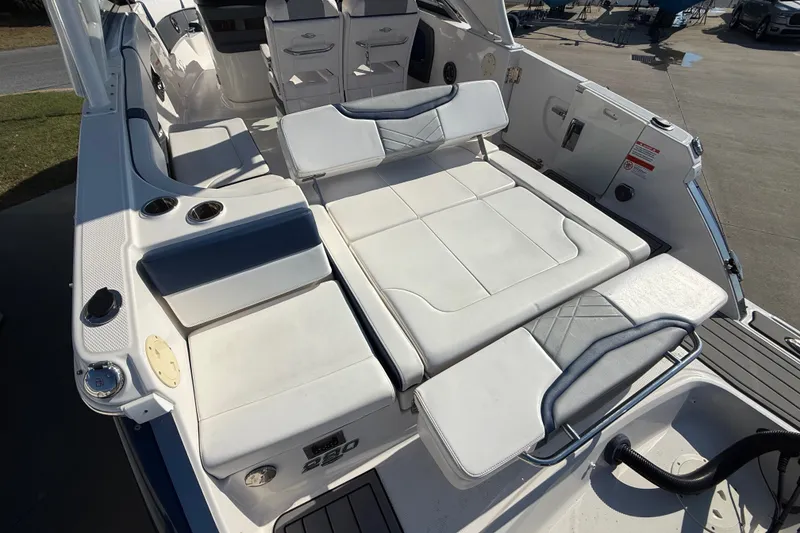 Slide: The Image of 2021 Chaparral 280 OSX boat interior with white seating and cup holders. - 25