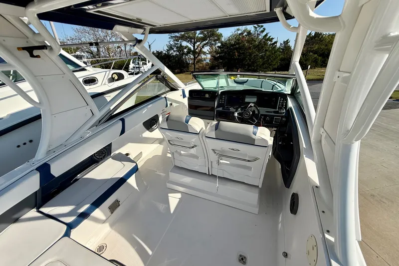 Slide: The Image of 2021 Chaparral 280 OSX boat interior with helm, seating, and modern design. - 19